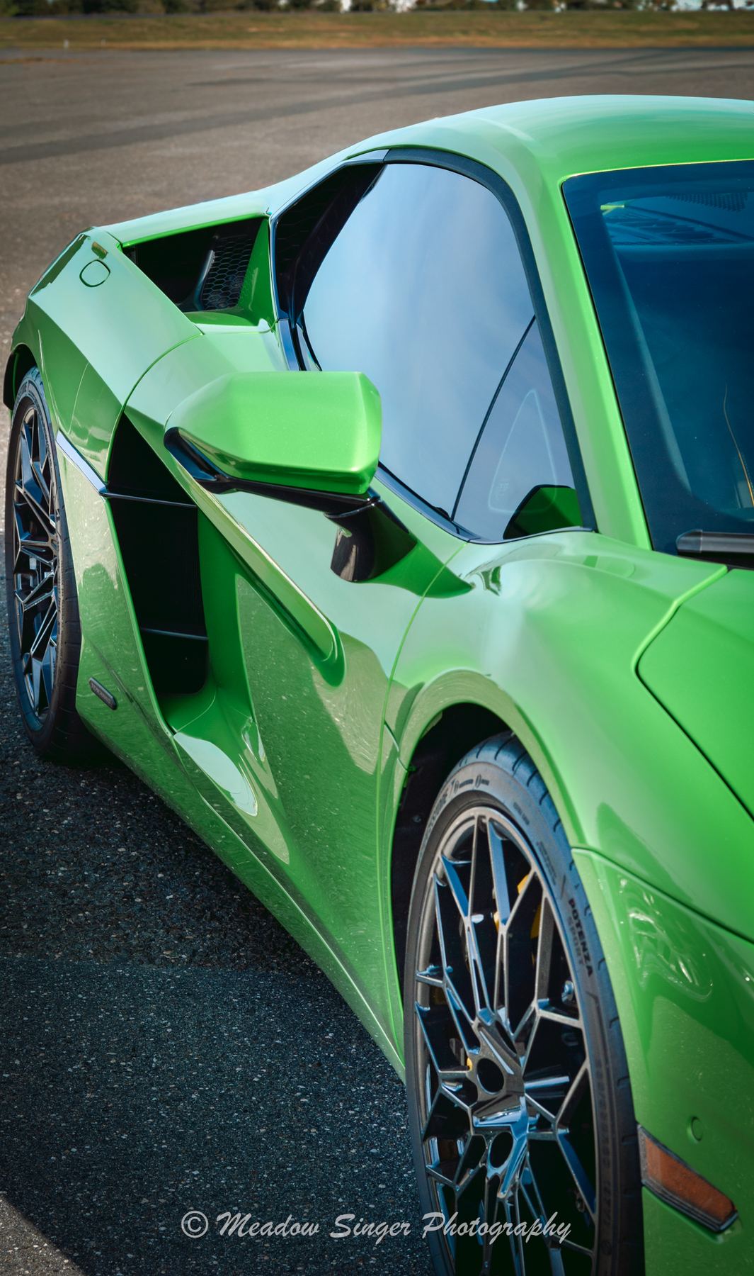 A lime green supercar parked on asphalt