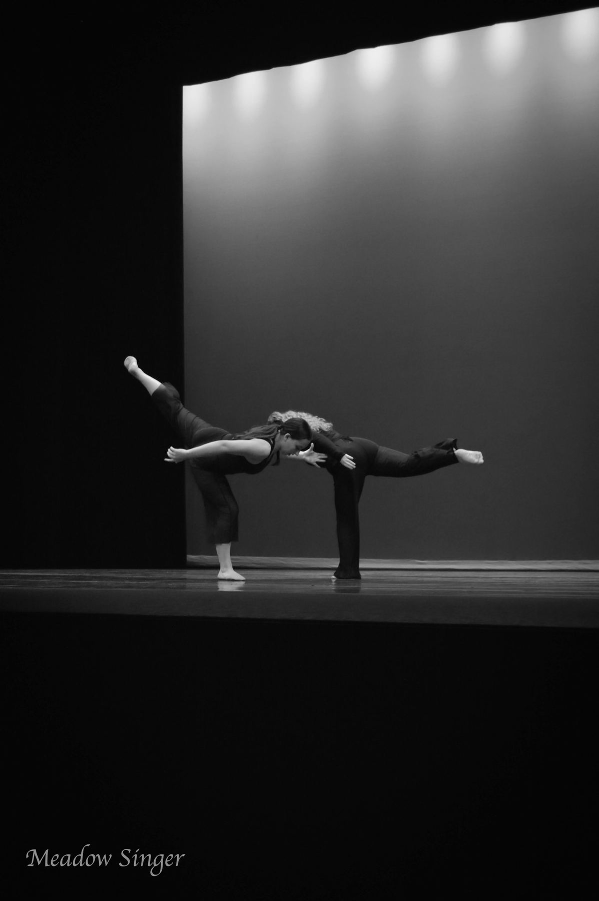 Black and white photo of two dancers on a dark stage
